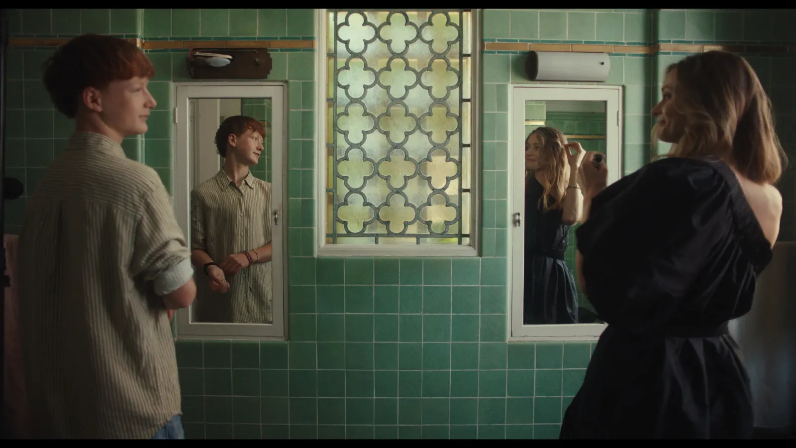 Teenager Otis (Sonny McGee) smiles at his Mum (Maeve Dermody) in the mirror