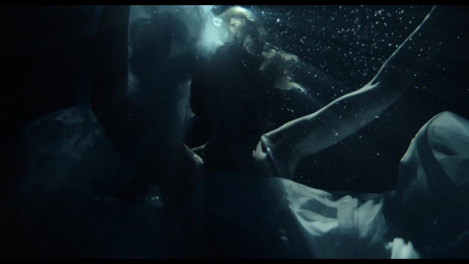 Maeve Dermody as Sarah, submerged underwater in a wedding dress in Life Could Be A Dream
