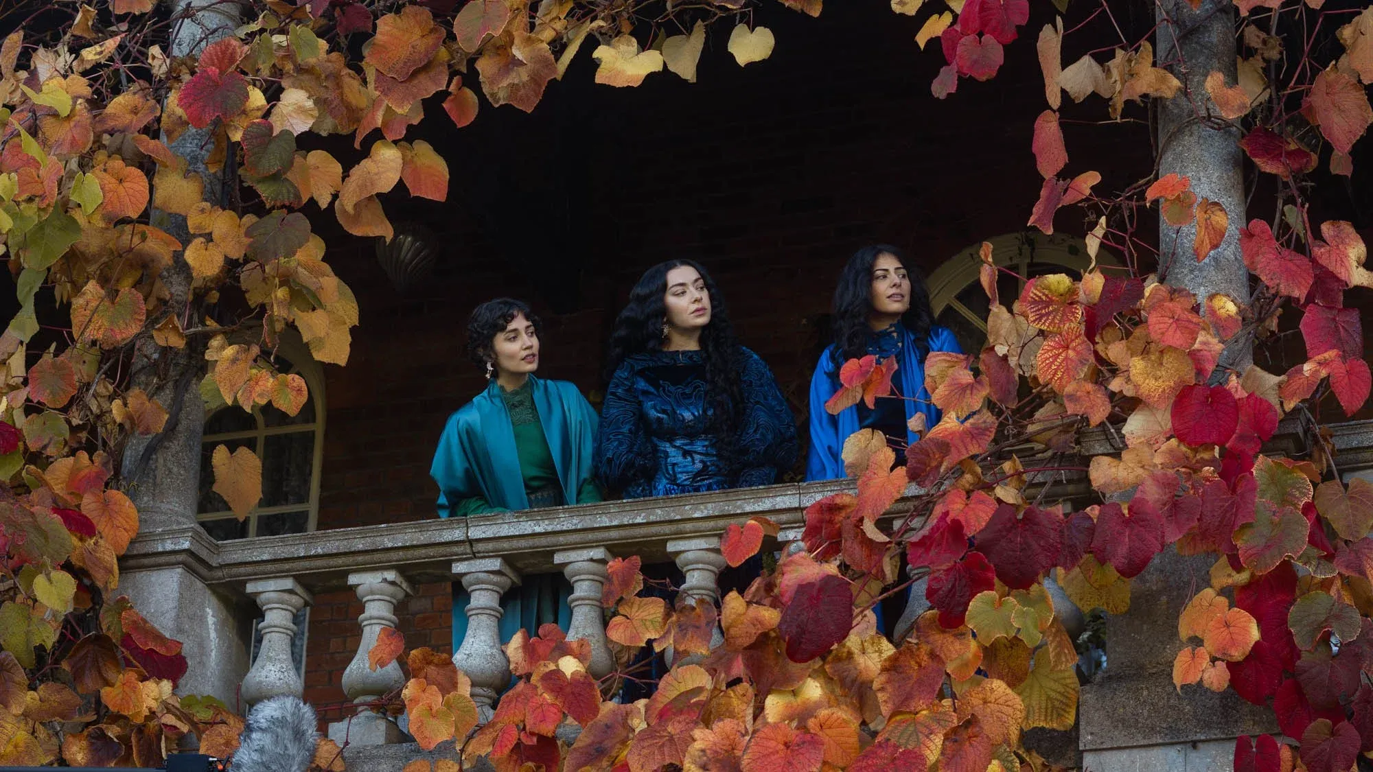 The three sisters including Charli XCX on an autumn balcony in 100 Nights of Hero (2025)