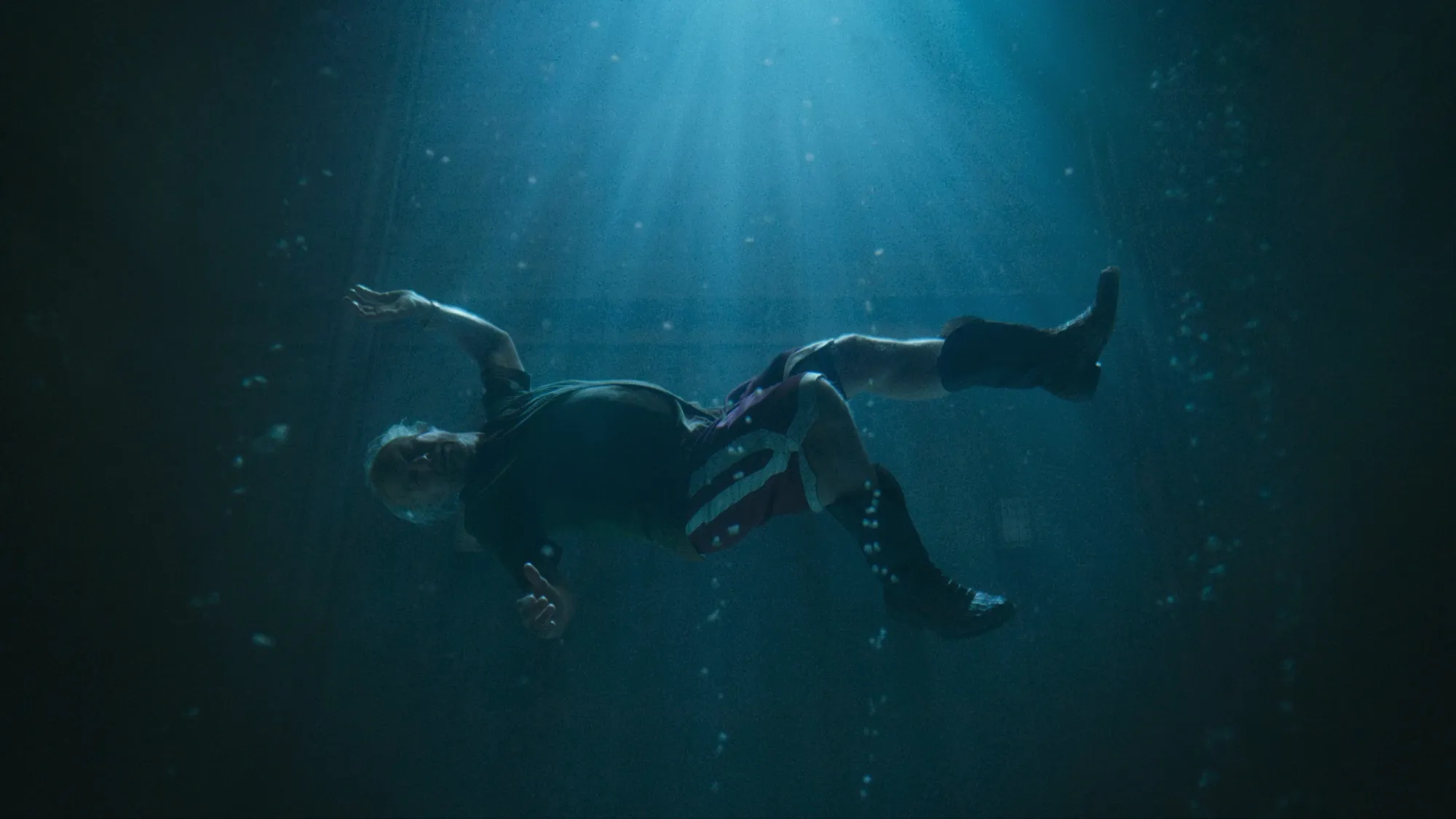 Tom Cruise artistically drowning in cowboy boots in the film Digger